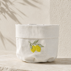 Off-white resin-coated linen bread baskets with yellow lemon embroidery by MI RE LA