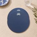 Blue resin-coated linen round placemat with off-white crab embroidery by MI RE LA