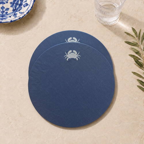 Blue resin-coated linen round placemat with off-white crab embroidery by MI RE LA