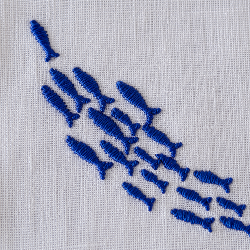 Embroidered pattern of blue fish on a white fabric background MI RE LA