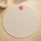 Oatmeal stone resin-coated linen round placemat with orange coral embroidery by MI RE LA