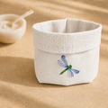 Off-white resin-coated linen basket with dragonfly blue embroidery by MI RE LA
