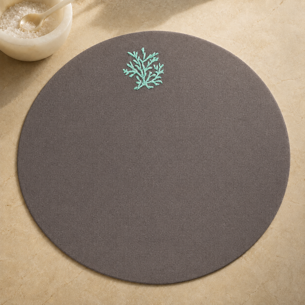 Dark taupe resin-coated linen round placemat with aqua coral embroidery by MI RE LA