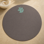 Dark taupe resin-coated linen round placemat with aqua coral embroidery by MI RE LA