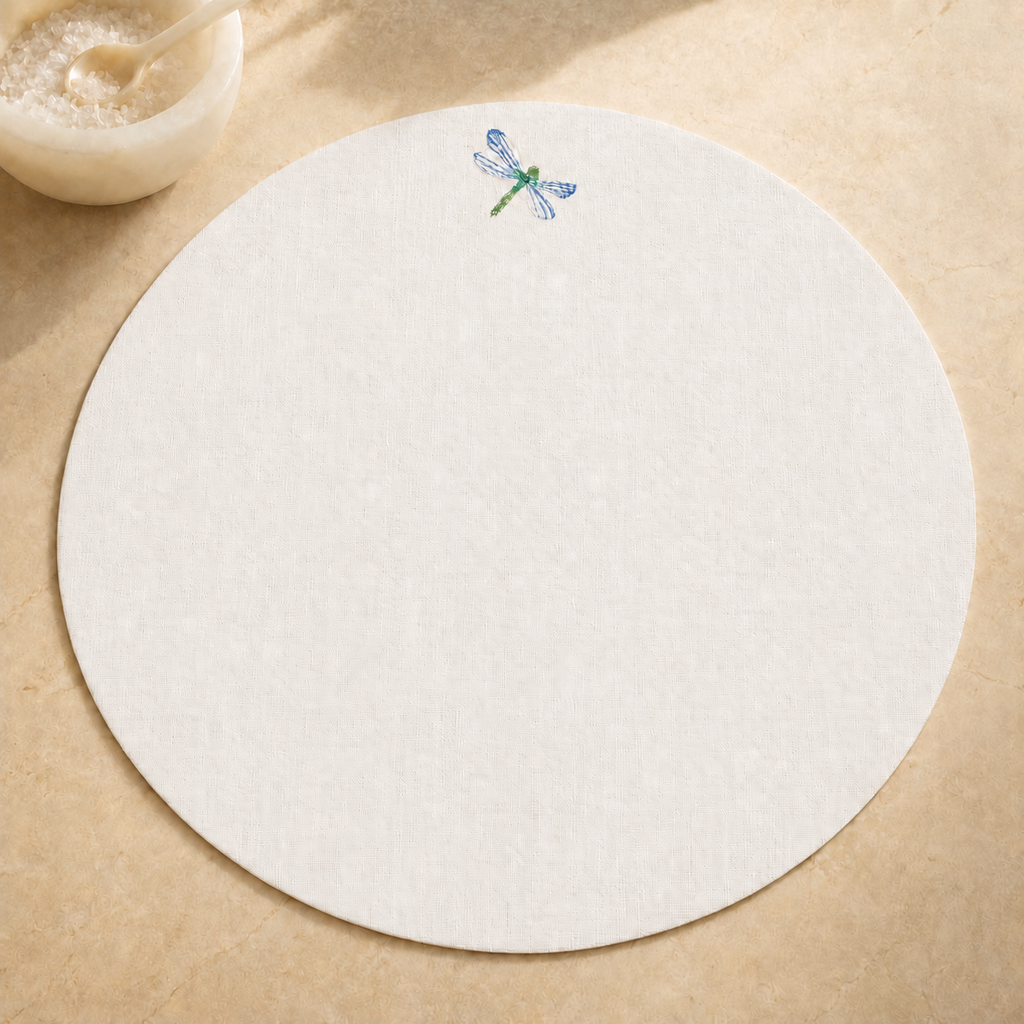 Off-white resin-coated linen round placemat with dragonfly blue embroidery by MI RE LA