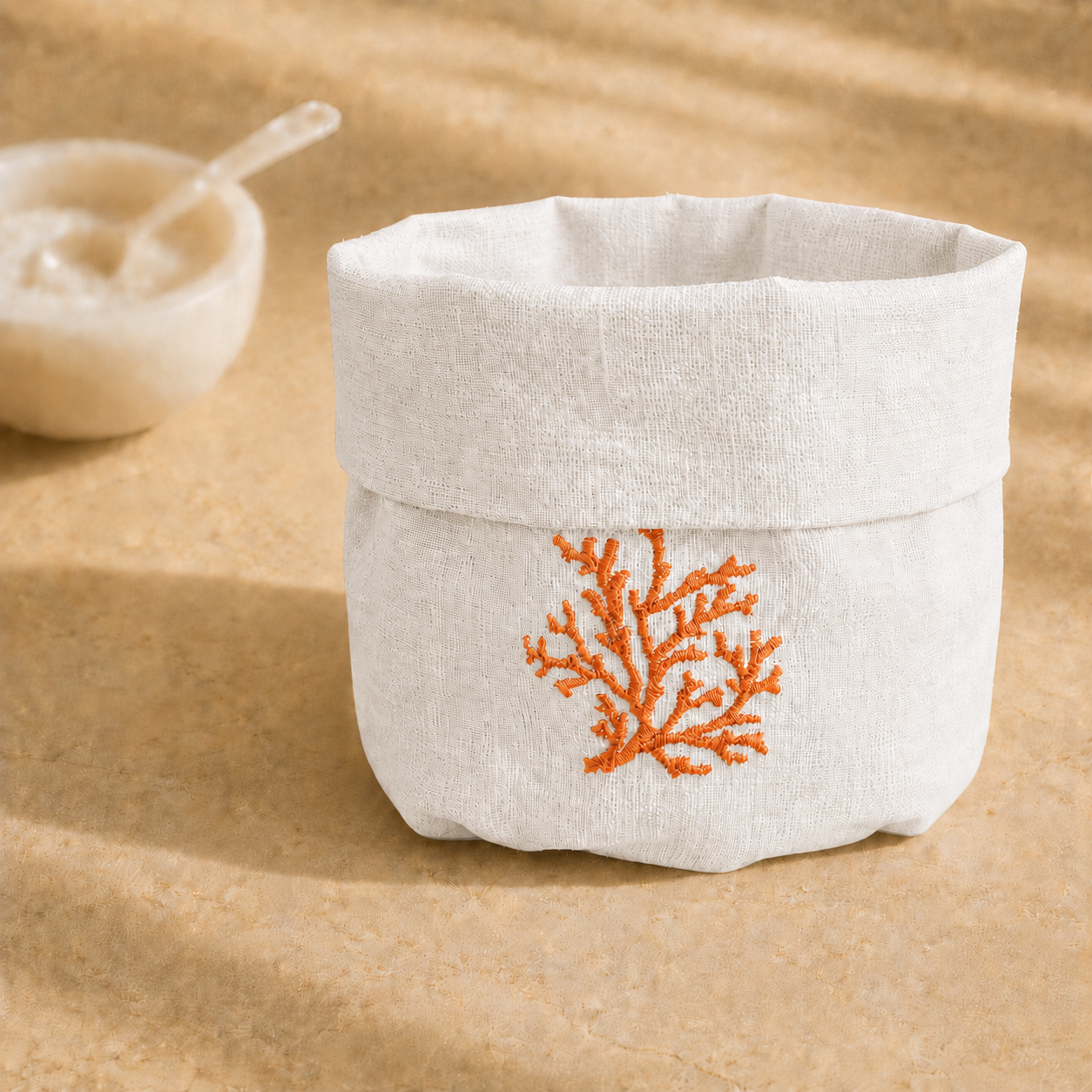 Off-white resin-coated linen basket with orange coral embroidery by MI RE LA