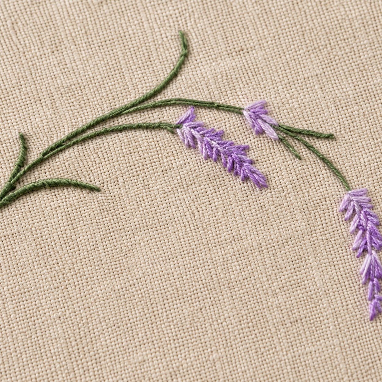 Embroidered lavender flowers on beige fabric